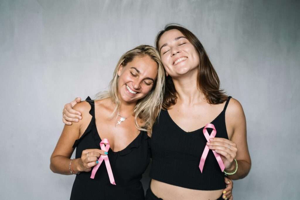 2 Women Holding Pink Ribbons