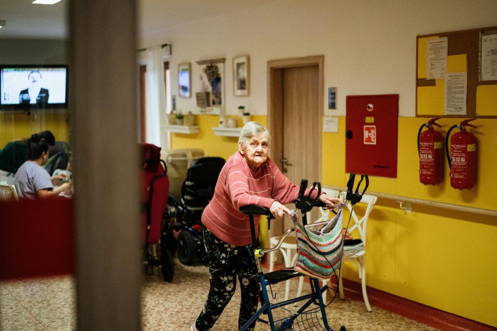 Senior woman using a walking frame in one of the best assisted living facilities in South Africa.