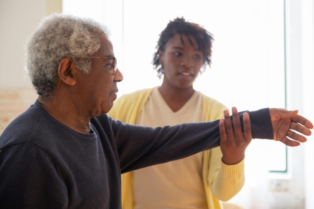 Alzheimer Care Facilities In Johannesburg 1 A caregiver helps an elderly man with arm exercises in a warm and caring Alzheimer Care Facilities In Johannesburg